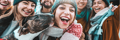 Laughing friends outdoors with their dog